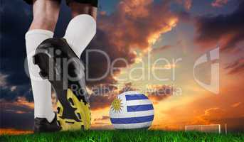 Composite image of football boot kicking uruguay ball