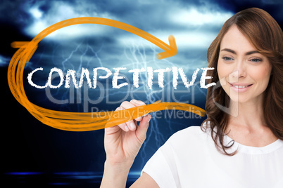 Businesswoman writing the word competitive