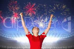 Composite image of cheering football fan in red