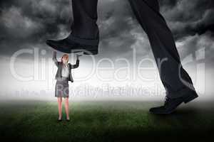 Composite image of businessman stepping on tiny businesswoman