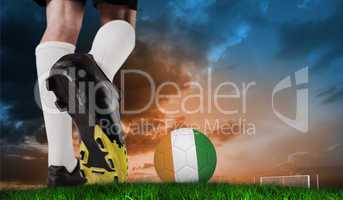 Composite image of football boot kicking ivory coast ball