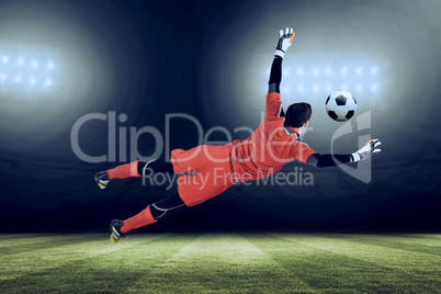 Composite image of fit goal keeper jumping up