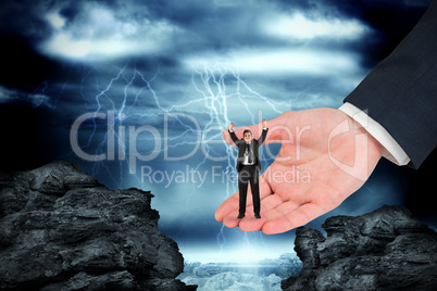 Composite image of businessman cheering at the camera in large h