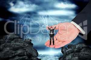 Composite image of businessman cheering at the camera in large h
