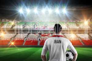 Composite image of iran football player holding ball