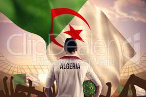 Composite image of algeria football player holding ball