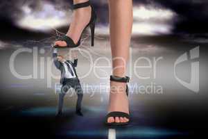 Composite image of female feet in black sandals stepping on busi