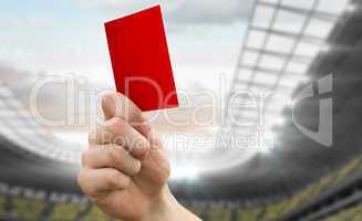 Composite image of hand holding up red card