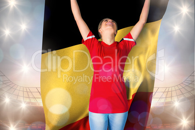 Composite image of cheering football fan in red holding belgium