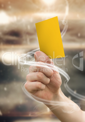 Composite image of hand holding up yellow card