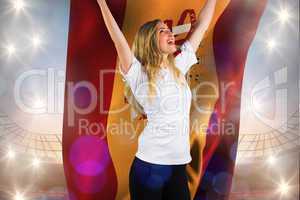 Composite image of pretty football fan in white cheering holding