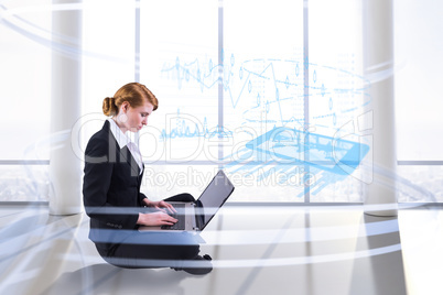 Composite image of redhead businesswoman using her laptop Composite image of redhead businesswoman using her laptop
