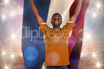 Composite image of cheering dutch football fan in orange jersey