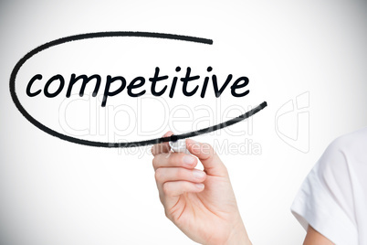 Businesswoman writing the word competitive