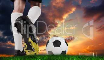 Composite image of football boot kicking ball