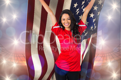 Composite image of cheering football fan in red holding usa flag