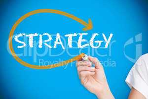 Businesswoman writing the word strategy