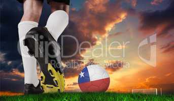 Composite image of football boot kicking chile ball