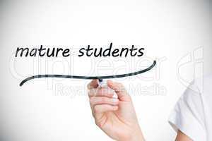 Businesswoman writing the words mature students