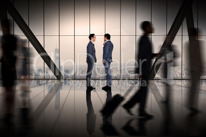 Composite image of businessmen talking