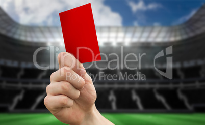 Composite image of hand holding up red card