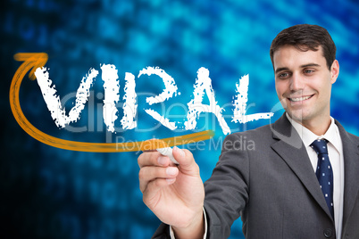 Businessman writing the word viral