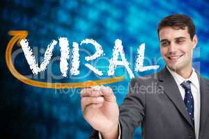 Businessman writing the word viral