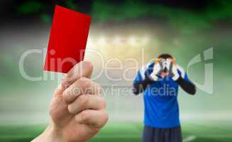 Composite image of hand holding up red card