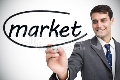Businessman writing the word market