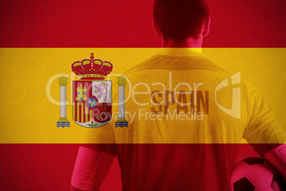 Composite image of spain football player holding ball