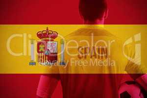 Composite image of spain football player holding ball