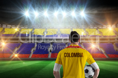 Composite image of colombia football player holding ball