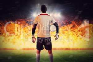 Composite image of goalkeeper standing in white jersey
