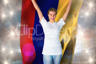 Composite image of pretty football fan in white cheering holding