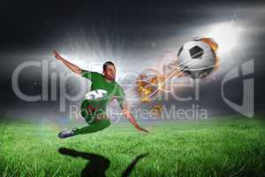 Composite image of football player in green kicking