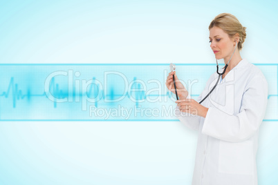 Composite image of blonde doctor listening with stethoscope