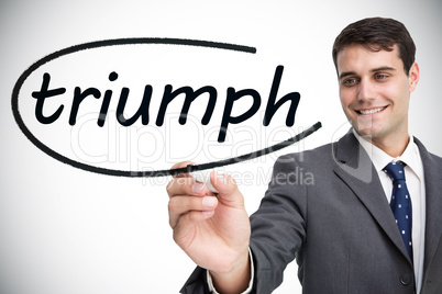 Businessman writing the word triumph