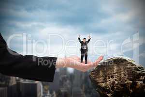 Composite image of businessman cheering at the camera in large h