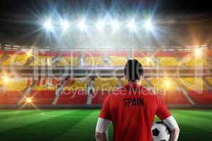 Composite image of spain football player holding ball