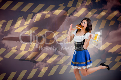 Composite image of pretty oktoberfest girl holding beer tankard