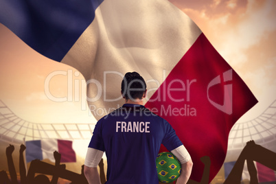 Composite image of france football player holding ball