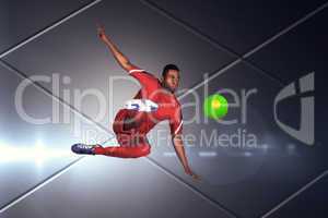 Composite image of football player in red kicking