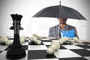Composite image of businessman standing under umbrella