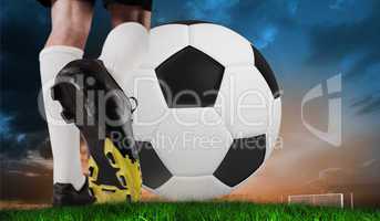 Composite image of football boot kicking huge ball