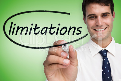 Businessman writing the word limitations