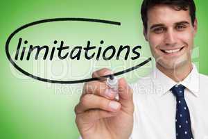 Businessman writing the word limitations