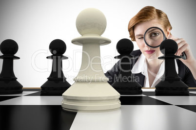 Composite image of focused businesswoman with magnifying glasses
