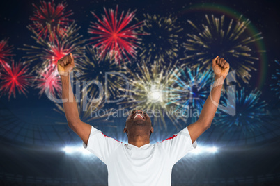 Composite image of excited handsome football fan cheering