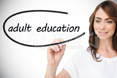 Businesswoman writing the words adult education