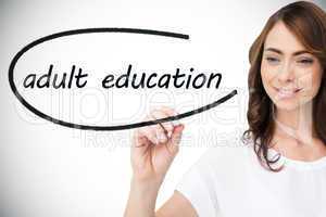 Businesswoman writing the words adult education